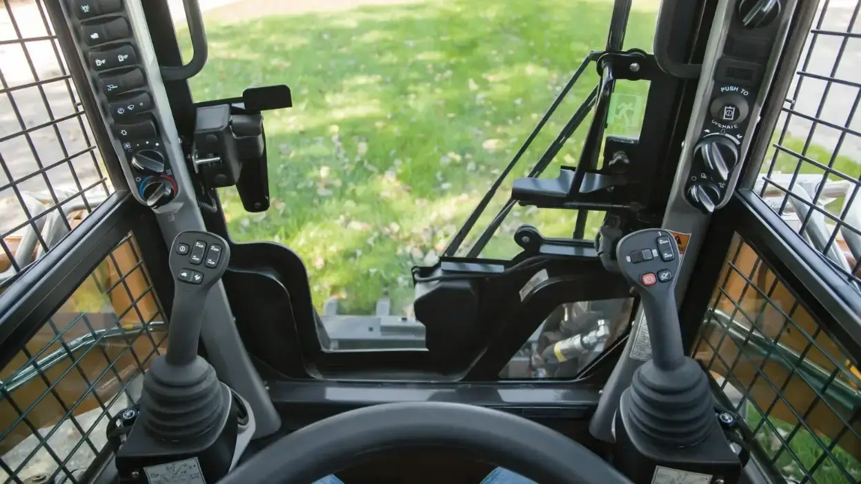 View from inside a CASE skid steer cab overlooking a job site